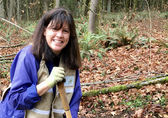 Kelly Gode, a Bellevue master naturalist, plants trees at Wilburton Hill Park.