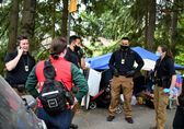 A Community Crisis Assistance Team confers about an individual in crisis at a homeless encampment.