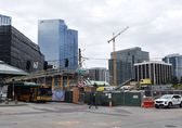 A man walks by a construction site in downtown Bellevue.