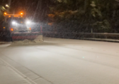 Snow plow in snowy conditions on Bellevue roadway