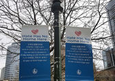 Banners saying "Hate has no home here," hang from a lamppost downtown.