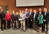IT staff accept awards at a City Council meeting.