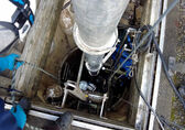 Utilities staff check on a pipe that goes deep underground.