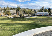 A large grass meadow dominates the new park at 112th Avenue and Main Street.