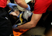 New firefighters demonstrate they know how to perform emergency treatment on another person.