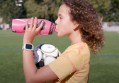 A girl drinks Bellevue water from a water bottle.