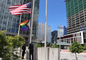 The Honor Guard raises the pride flag at City Hall.