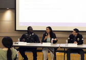 Panelists speak at a meeting about hate crimes and bias incidents.
