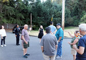 People talk on a street in Surrey Downs for Neighborhood Walks.