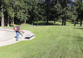 A man with a leaf blower tends to Crossroad Park.