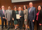Councilmember Conrad Lee, center, accepts a commendation for his many years on the council.