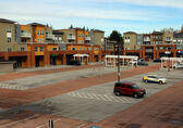 There are many empty parking stalls at a Bellevue shopping center.