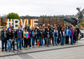 A Bellevue Essentials class stands together on the City Hall plaza.