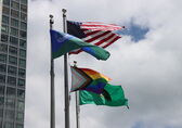 The pride flag flies alongside ones for the city, state and country.