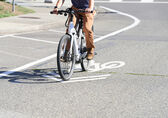 A person rides an e-bike on a Bellevue street.