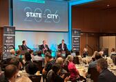 Mayor Mo Malakoutian (right) and Deputy Mayor Dave Hamilton (center) discuss Bellevue while seated on the stage at Meydenbauer Center.