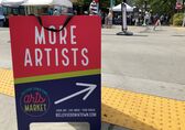 The rewritten sign code covers temporary signs as well, like this sandwich board calling for artists at the downtown arts market.