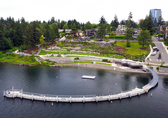 The beach and pier of Meydenbauer Bay Park seen from above, with downtown Bellevue behind them.