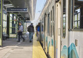 People board the 2 Line at the 130th Street station.