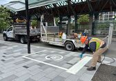 A contractor marks a large rectangle on a Bellevue sidewalk where Lime devices should be parked.
