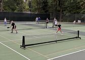 People play pickleball on outdoor pickleball court.
