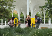 A family plays by the grant-funded Piloti sculpture at Downtown Park.