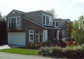 A detached accessory dwelling unit stands on a neighborhood corner.