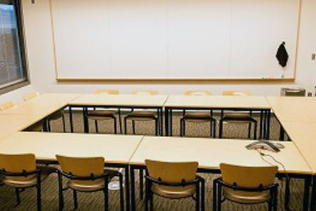 Meeting room with desks in a square shape and chairs with easy access