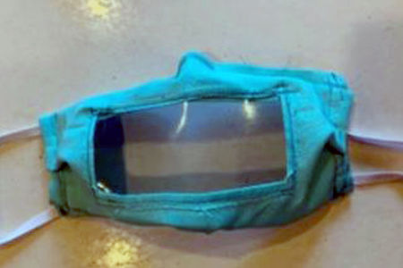 A mask with a clear window for mouth to see speech
