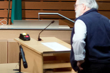 A man using a microphone on a podium