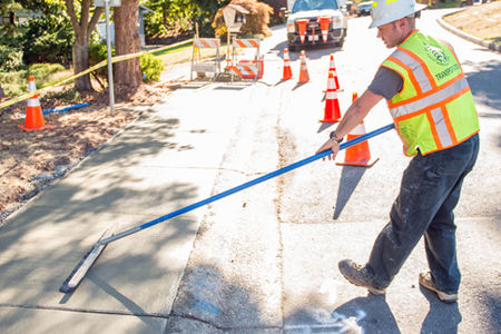 A road crew worker creating an accessible sidewalk