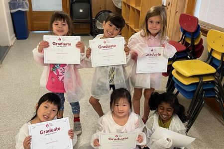 Children holding up certificates