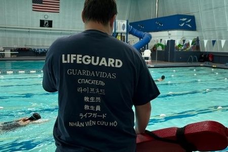 lifeguard wearing a translated lifeguard t-shirt