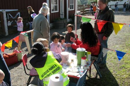 A volunteer is painting kids' faces at an event