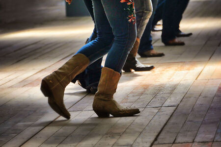A closeup shot of the legs of traditional western folk dancing under the music