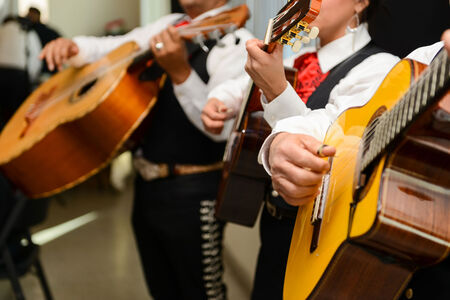 Close up of Mariachi musicians playing guitar