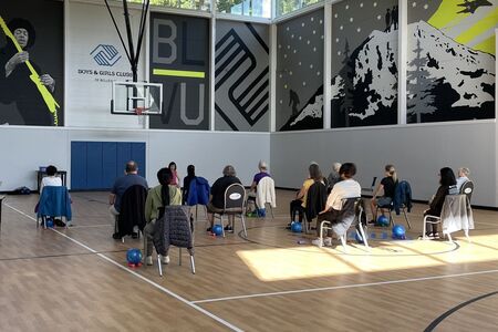 Seniors at a SilverSneakers health and fitness class at a community center
