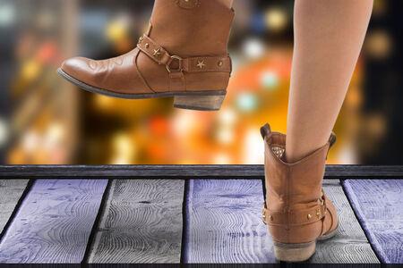 Woman's feet with Party boots  over night city