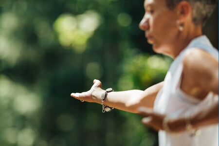 woman practicing tai chi outdoors