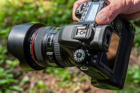 hand holding a DSLR Camera