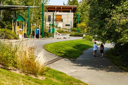 Lewis Creek Park Visitor Center and playground with people walking on the trail
