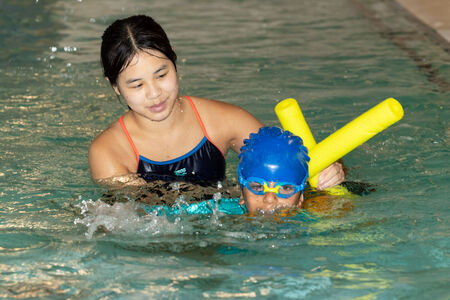 Swim instructor and student lesson in the pool at Bellevue Aquatic Center