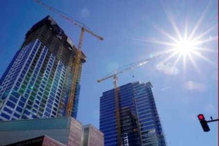 image of downtown skyline with construction cranes
