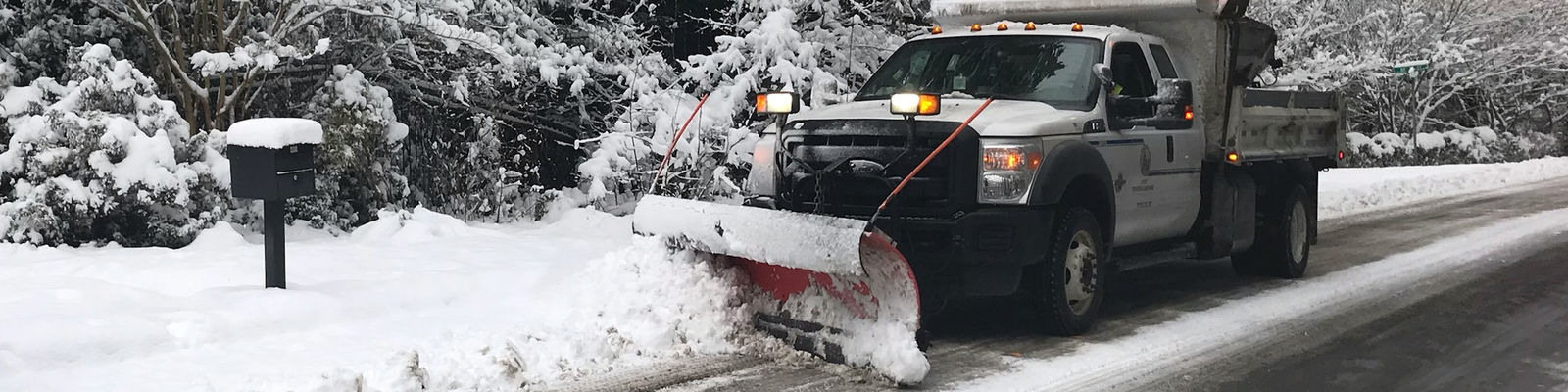 A snowplow clears a Bellevue street.