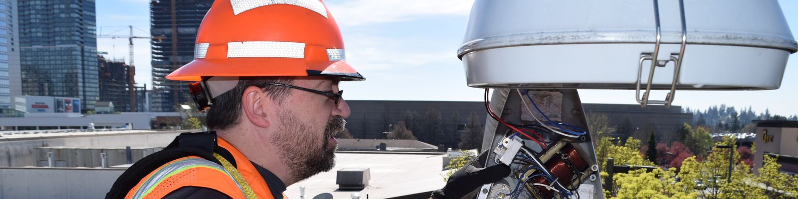 Image of street maintenance worker and street light