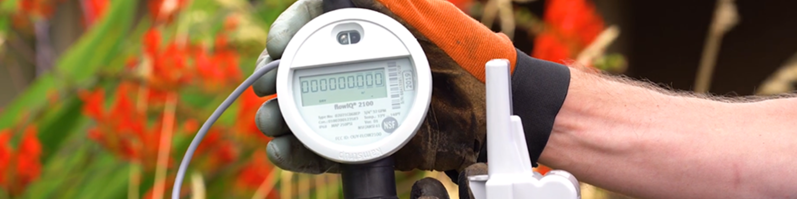 Hand holding a smart water meter ratio transmitter device
