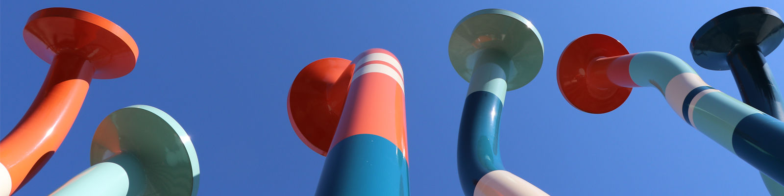 Image of Christian Moeller’s “Nails” sculpture. Brightly painted, and large-scale nails reach toward the sky next to Sound Transit’s Link light rail base in BelRed.