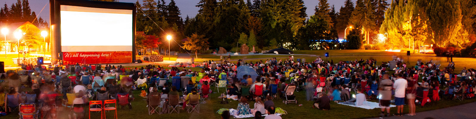 Crowd of people watching movie at Crossroads Park