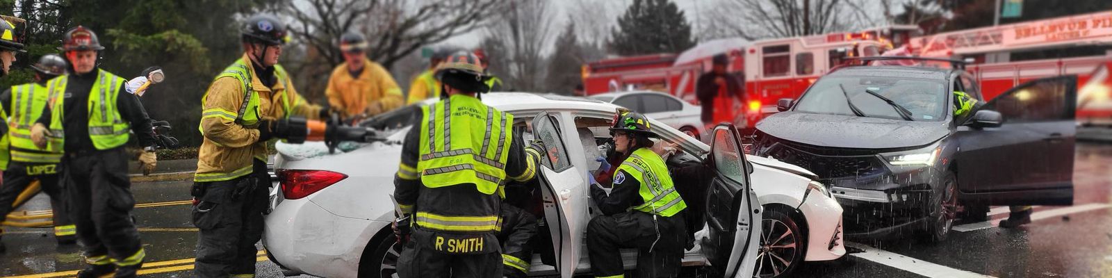 Photo of Bellevue firefighters stabilizing a vehicle after a collision.