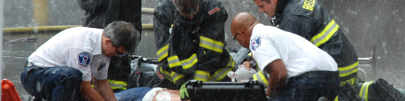 Bellevue firefighters and paramedics run a realistic cardiac arrest drill in pouring rain. 